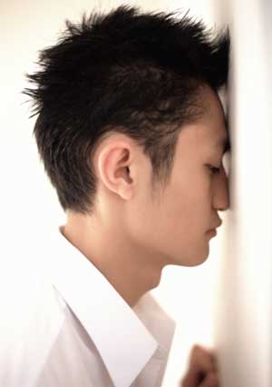 Man with His Head Against a Wall